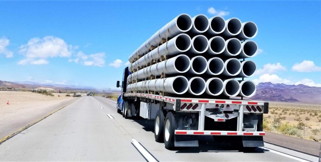 Truck hauling pipes